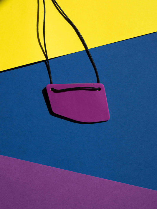 Back magenta view of a salvaje pendant in magenta, yellow and purple colours with strong lighting on a colourful background